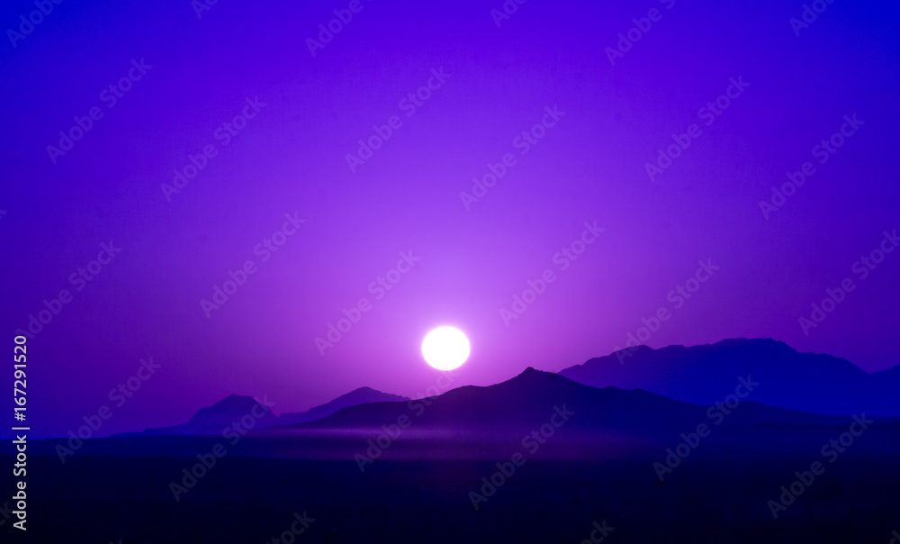 View on Purple sunrise over mountains in dessert of Iran