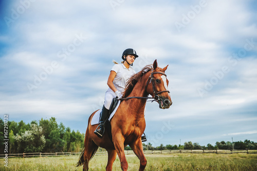 Fényképezés Girl jockey riding a horse