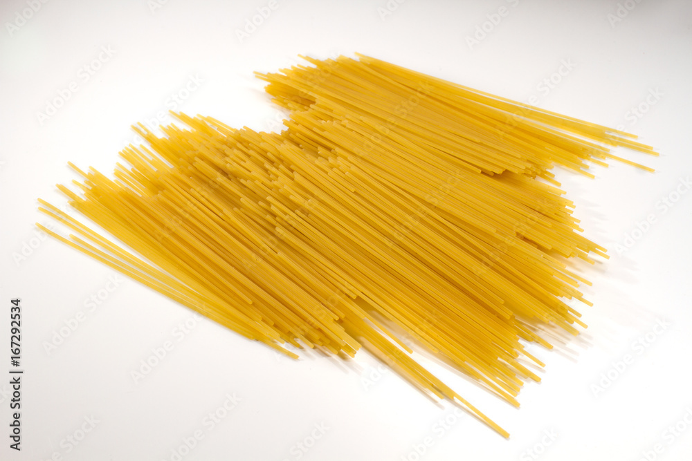 A heap of long yellow pasta isolated on a white background A heap of long yellow pasta isolated on a white background