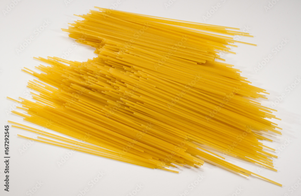 A heap of long yellow pasta isolated on a white background A heap of long yellow pasta isolated on a white background