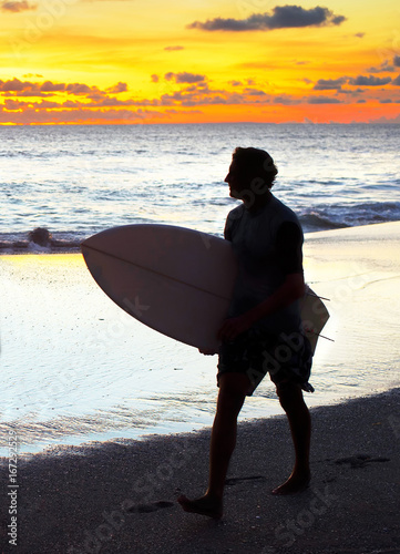 Surfer at sunset. Bali island