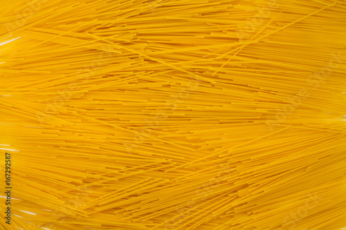 A heap of long yellow pasta isolated on a white background