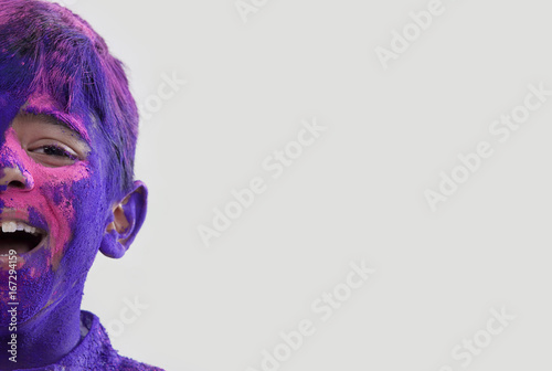 Boy covered with holi colours 