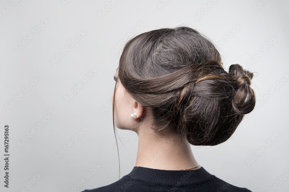 hairstyle bun on the brunette on isolated light background hairstyle bun on the brunette on isolated light background