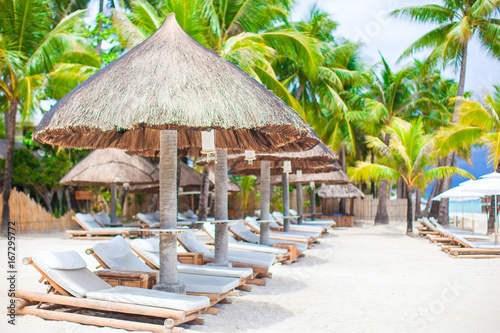 Beach beds on luxury resort on exotic tropical white sandy beach