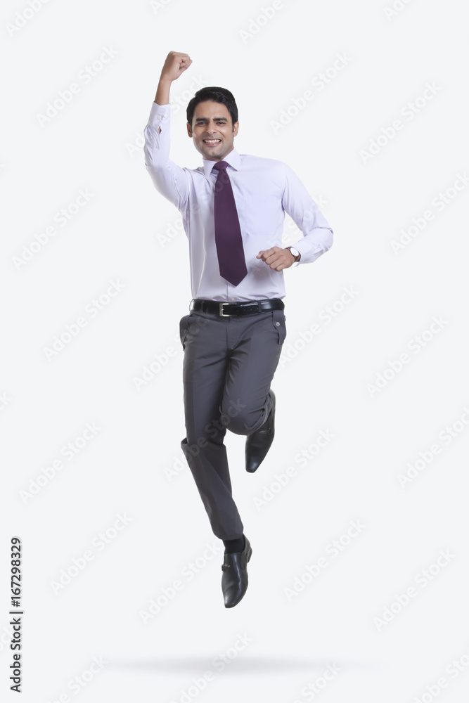 Portrait of a male executive jumping in the air Portrait of a male executive jumping in the air