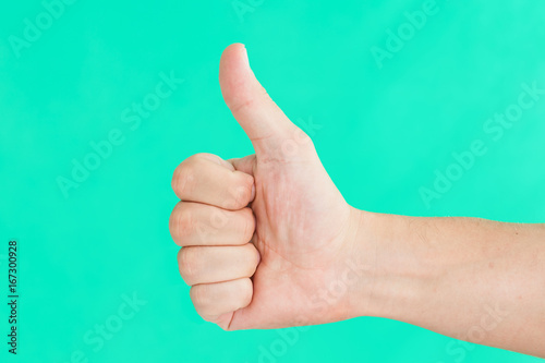 Thumb up hand isolated on green screen. © Paweł Michałowski