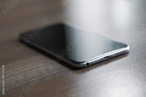 Close-up of a smartphone lying on a wooden table
