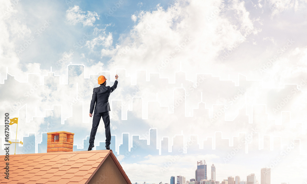 Man architect draw silhouette of modern city on blue sky. Mixed 
