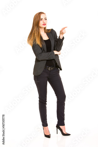 Dark blonde woman wearing smart casual outfit pointing at something on white background