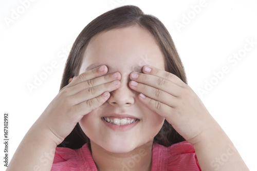 Little girl covering her eyes