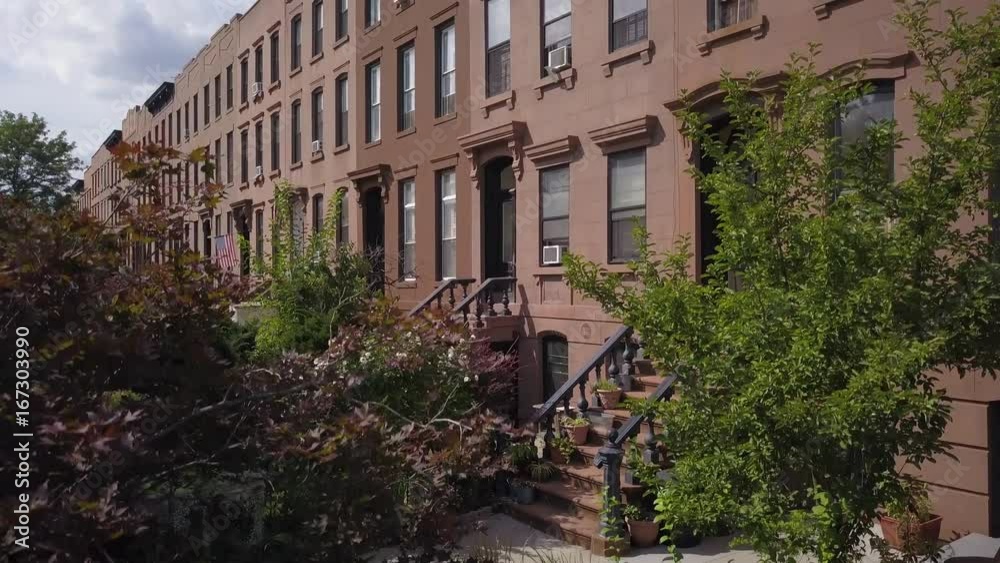 rising over trees to reveal block of Brownstones in Brooklyn rising over trees to reveal block of Brownstones in Brooklyn
