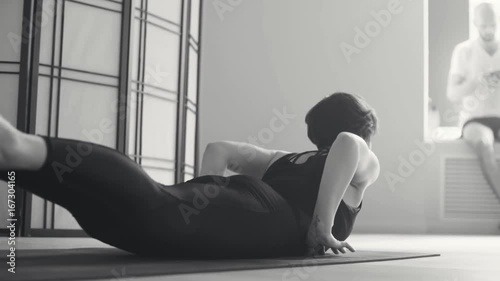 A young woman performing yoga-asanas photo