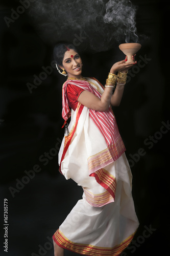 Portrait of Bengali woman doing dhunuchi dance photo