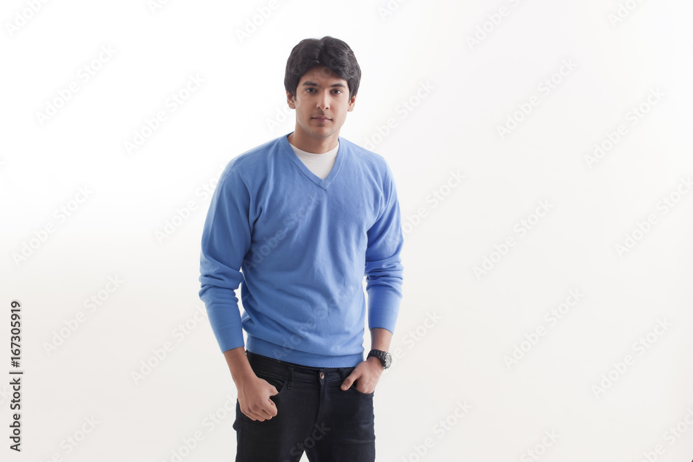Portrait of young man standing with hands in pockets Portrait of young man standing with hands in pockets