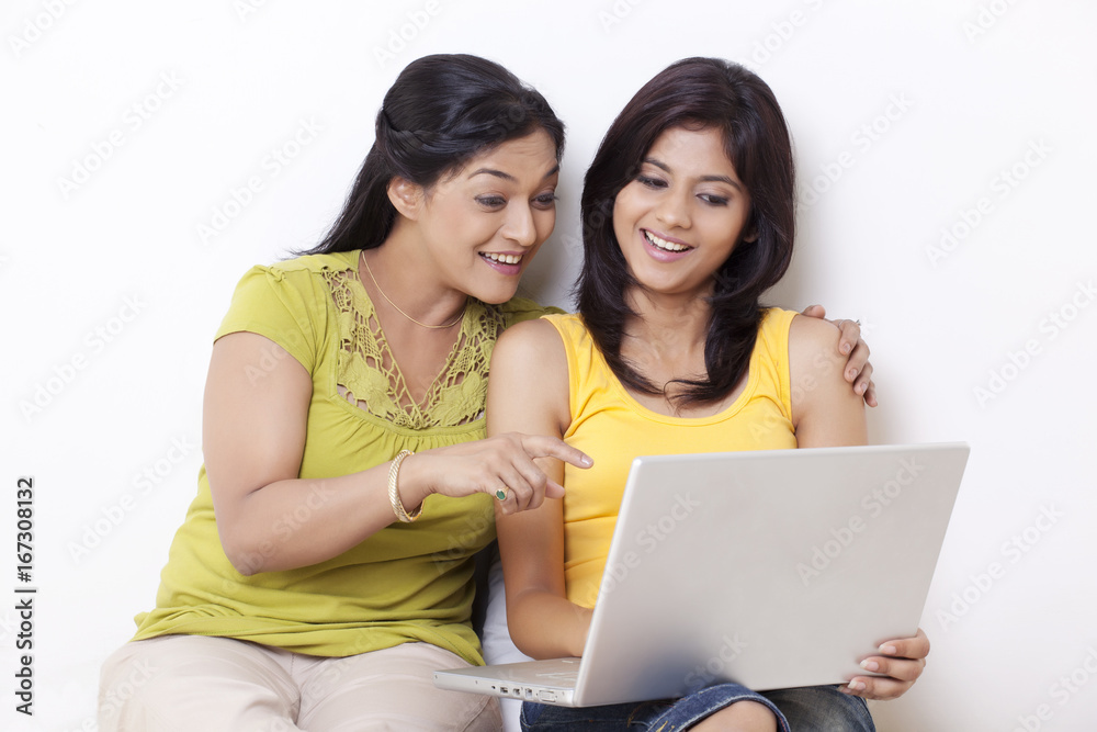 Happy mother and daughter using laptop Happy mother and daughter using laptop
