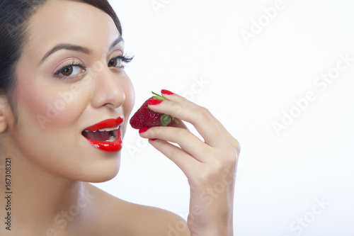 Portrait of a woman about to eat a strawberry