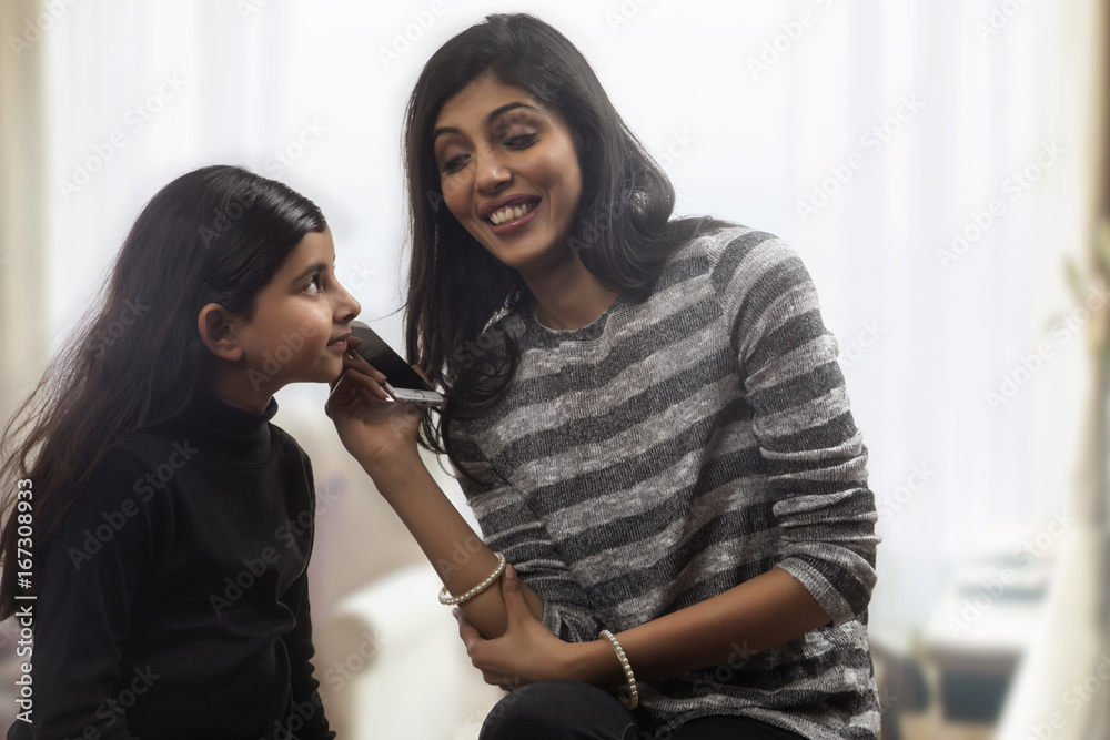Happy mother and daughter sharing a phone conversation Happy mother and daughter sharing a phone conversation