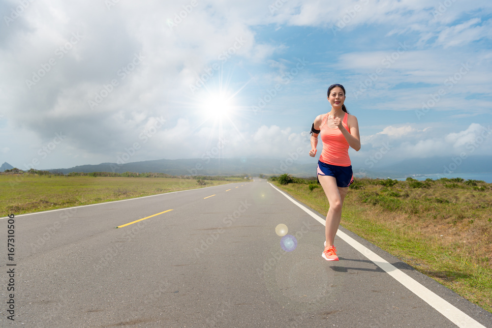 beautiful female athlete running on asphalt road beautiful female athlete running on asphalt road