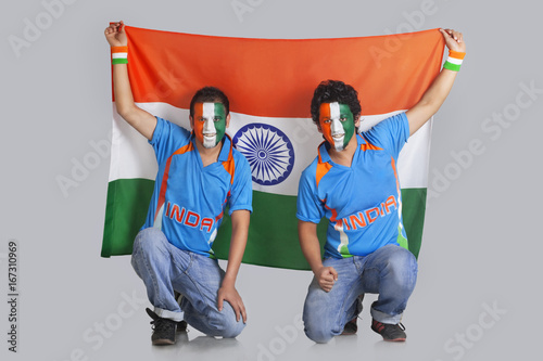 Photography Two male friends with face painted in a tricolor holding Indian flag over colore