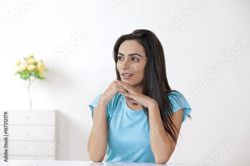 Thoughtful young woman relaxing at home