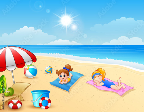 Two girl sunbathing on the beach mat