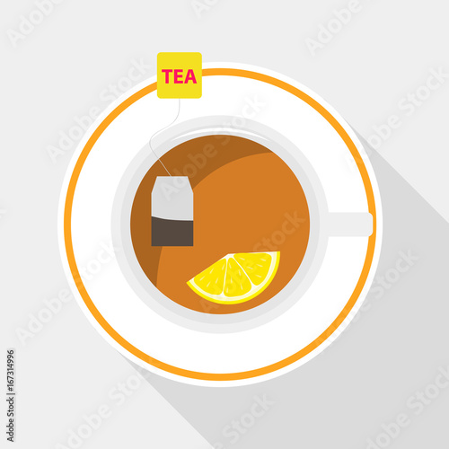 A tea bag with lemon is brewed in a cup