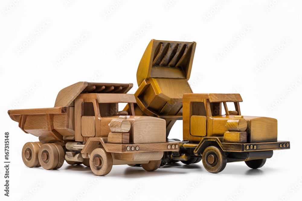 Two truck-dumper toys are wooden hand made.