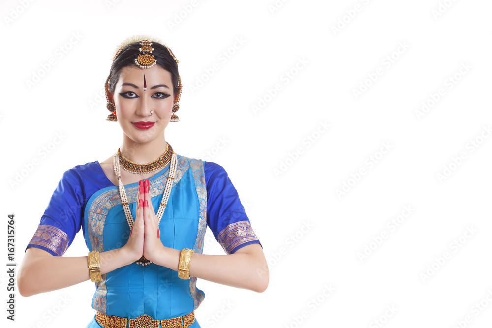 Portrait of happy Bharatanatyam dancer in prayer position over white background Portrait of happy Bharatanatyam dancer in prayer position over white background