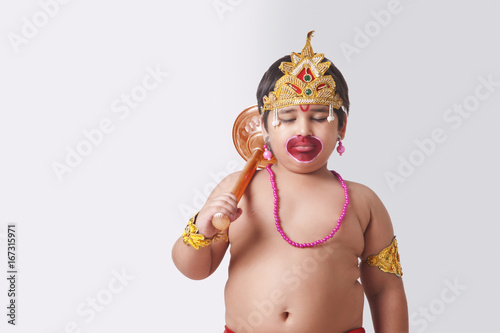 Fototapeta Naklejka Na Ścianę i Meble -  Cute boy dressed as God Hanuman against white background