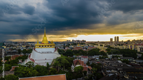  'Golden Mountain ' Wat Saket Ratcha Wora Maha Wihan popular Bangkok tourist attraction , Landmarks of bangkok Thailand . In the rain before , topview