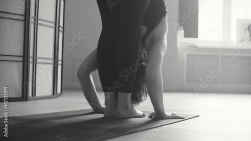 A young woman performing yoga-asanas photo
