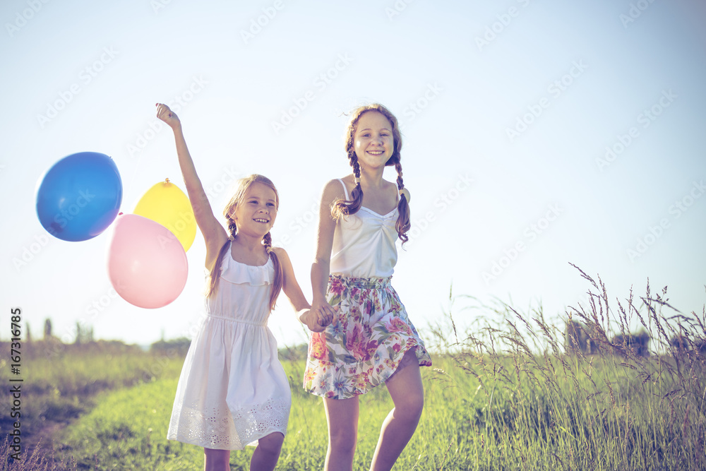 Happy little children playing in the field at the day time. Happy little children playing in the field at the day time.