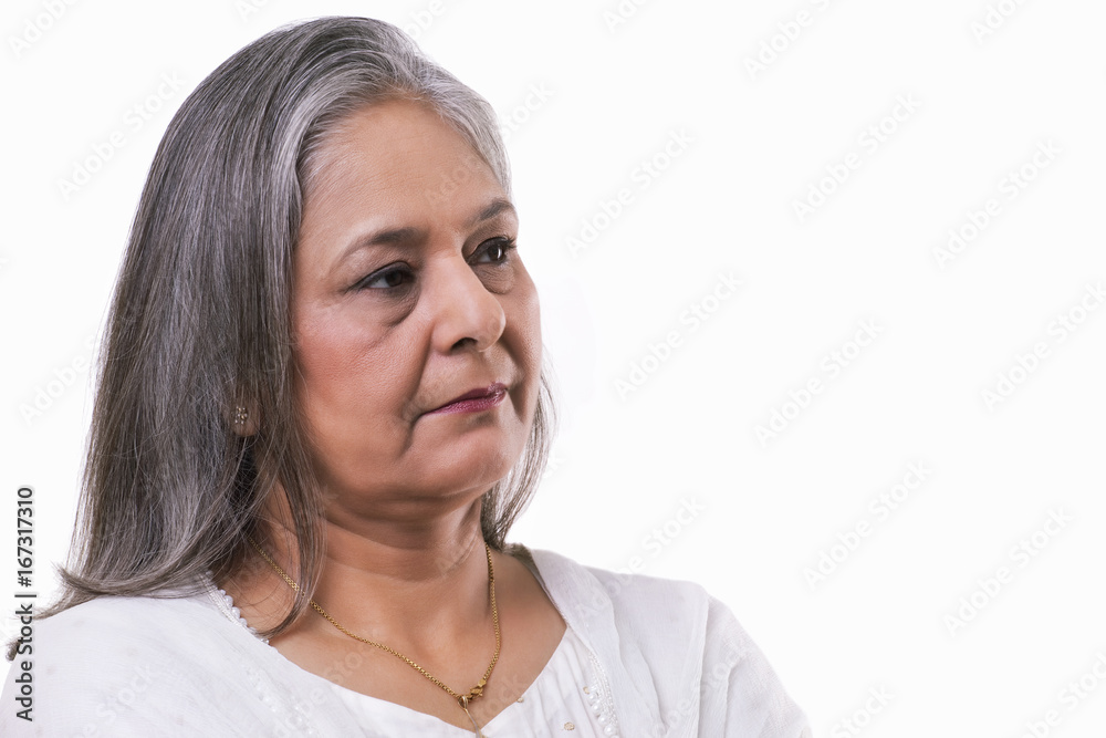 Mature woman lost in thoughts over white background Mature woman lost in thoughts over white background