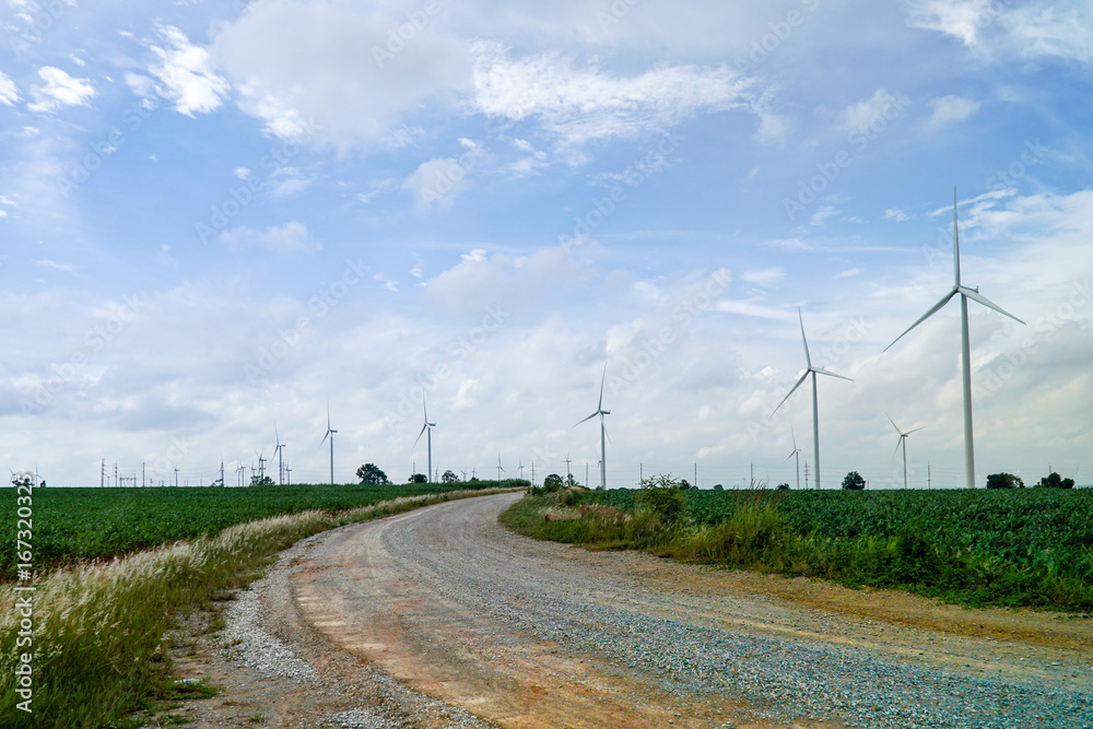 Wind turbines generating electricity with green meadow - Eco power