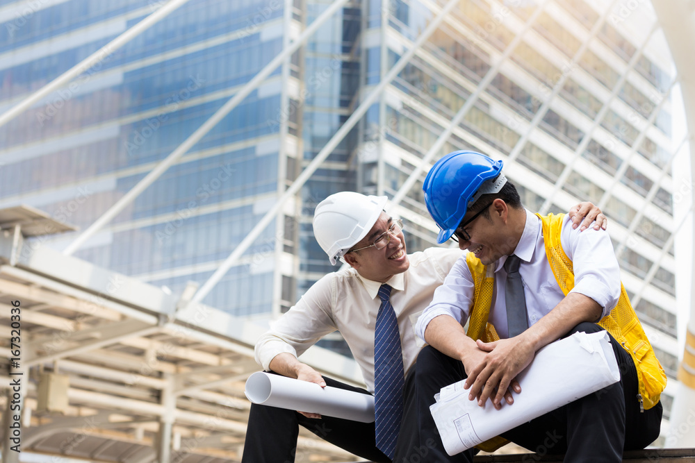 Happy moment of Architect and construction engineer or surveyor discussion plans and blueprints,urban background Happy moment of Architect and construction engineer or surveyor discussion plans and blueprints,urban background