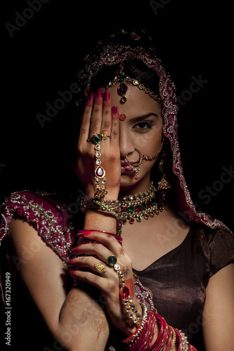 Portrait of Indian bride hiding half her face 