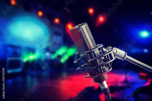 Professional studio microphone on stage during concert, blurred background