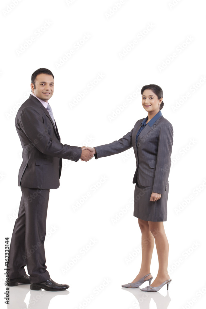 Businessman and businesswoman shaking hands isolated over white background Businessman and businesswoman shaking hands isolated over white background