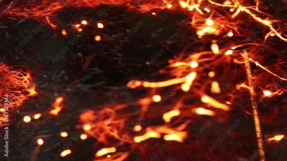 Close up, flames burn through strands of steel wool Close up, flames burn through strands of steel wool