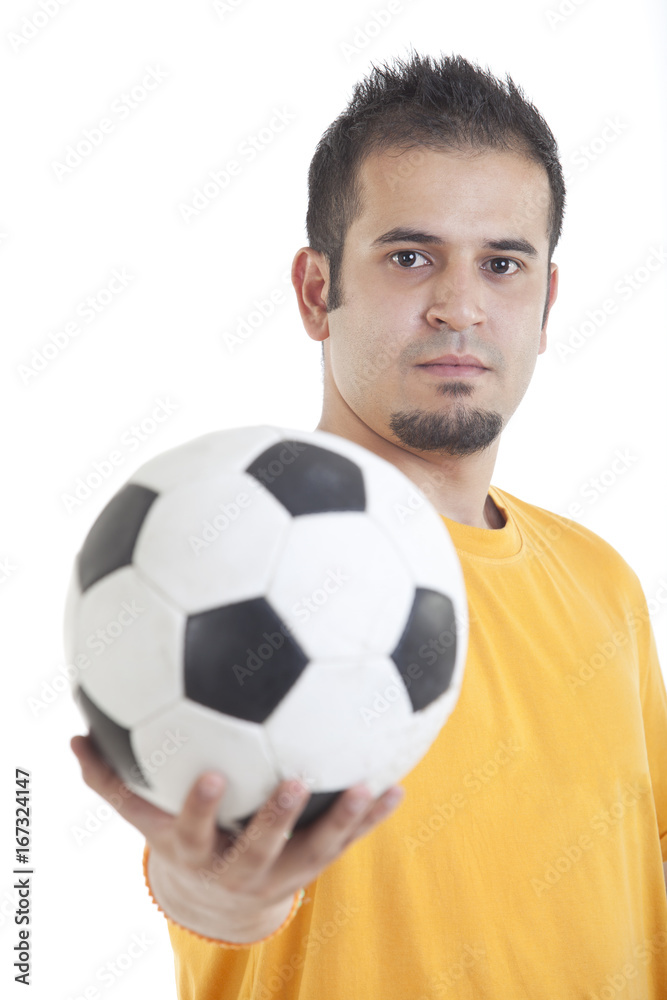 Portrait of young man holding soccer ball over white background Portrait of young man holding soccer ball over white background