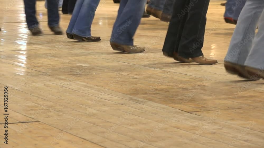 Cowboy dancing country line dance at a folk event, USA style. Legs stepping choreography American horse festival. Tradition jeans boots and flag Cowboy dancing country line dance at a folk event, USA style. Legs stepping choreography American horse festival. Tradition jeans boots and flag