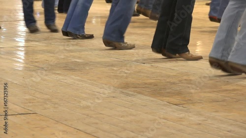 Cowboy dancing country line dance at a folk event, USA style. Legs stepping choreography American horse festival. Tradition jeans boots and flag