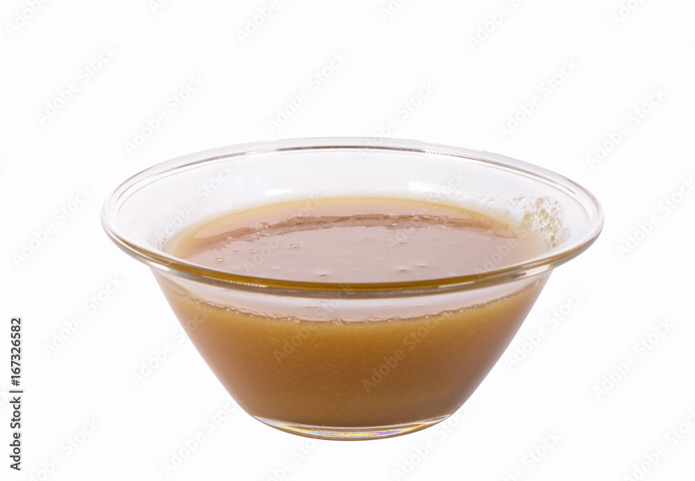 Honey in a glass bowl isolated on the white background. Honey in a glass bowl isolated on the white background.