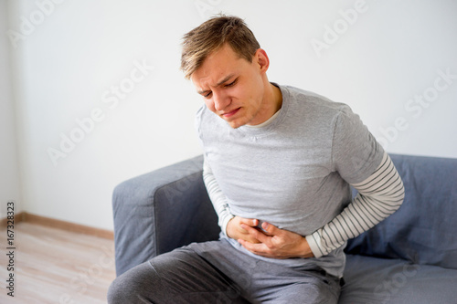 Guy suffering from a stomachache photo