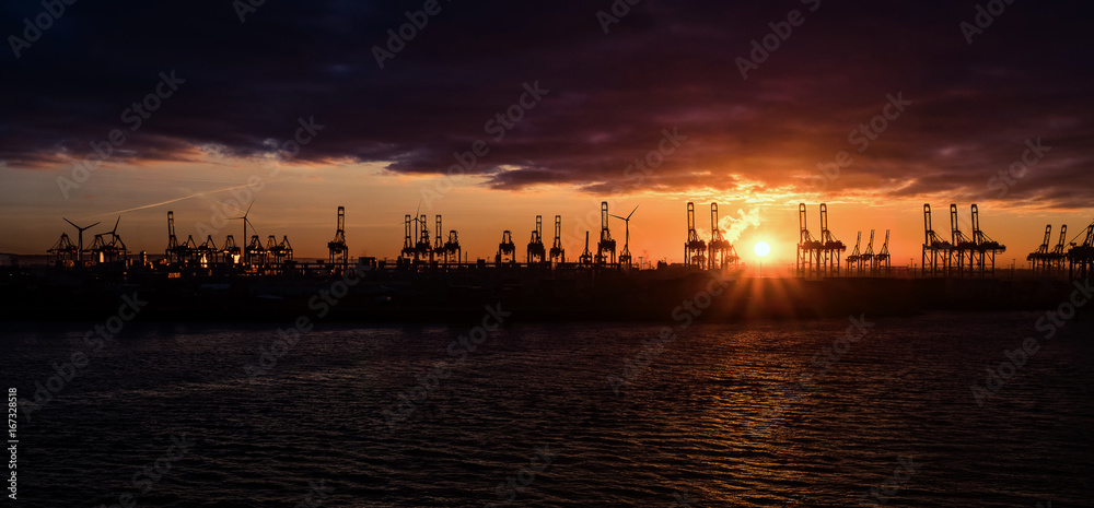 Sunset with heavy clouds over the Hamburg harbor
