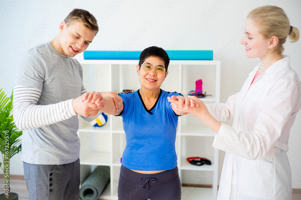 Physiotherapist helping a senior woman Physiotherapist helping a senior woman