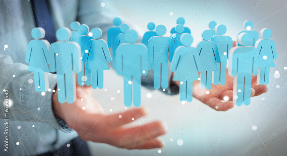 Businessman holding 3D rendering group of people in his hand