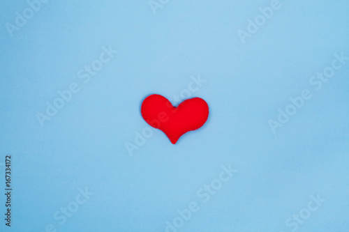 Red heart on blue background from top view with space for copy. Valentines day concept.