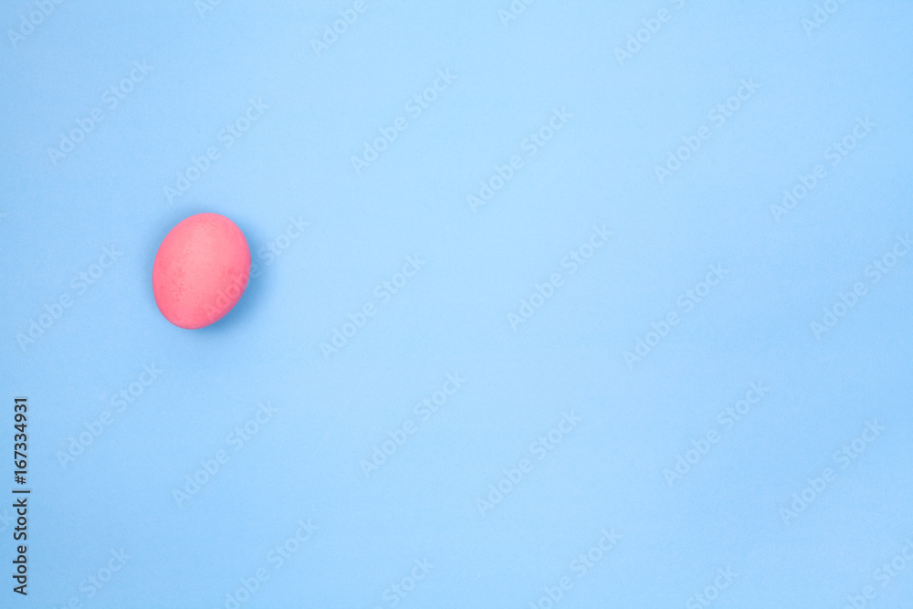 one preserved egg on blue background with space for copy. one preserved egg on blue background with space for copy.